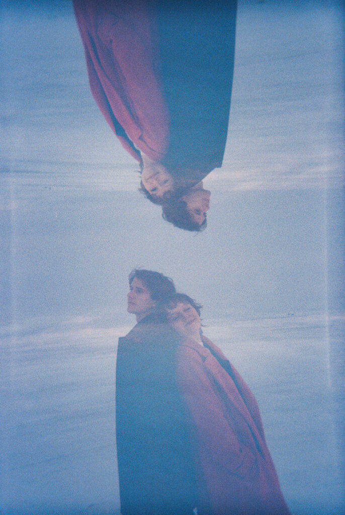 Upside-down double-exposure film portrait of a couple beside the frozen lake at Lake St. Clair Metropark.