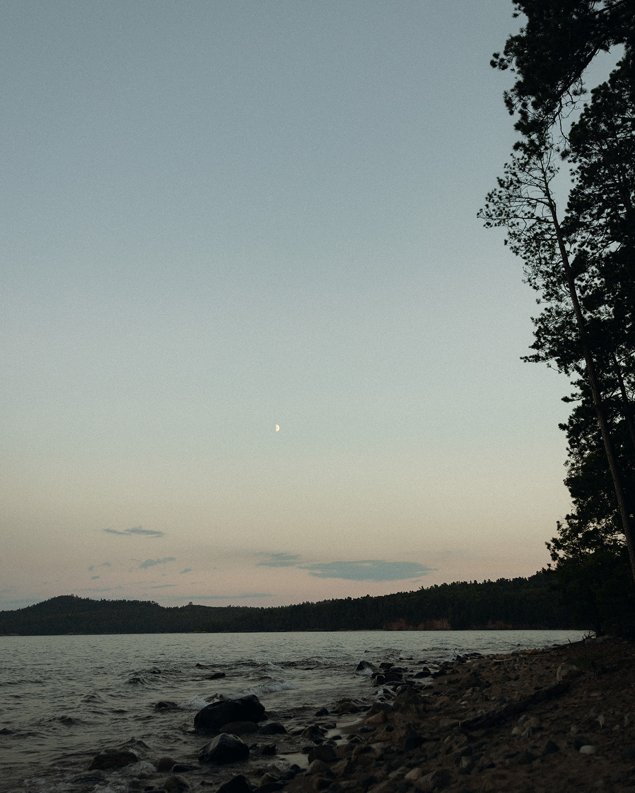 Photo of the shoreline on Little Presque Isle in Marquette Michigan at dusk.