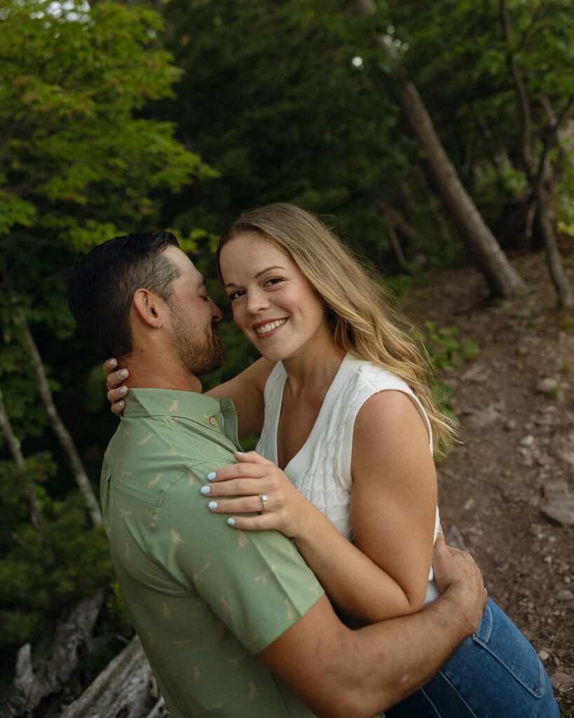 Couple standing close together and posing for a photo.